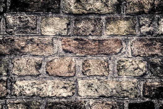 Aged and weathered old brick wall texture in a vintage retro design 