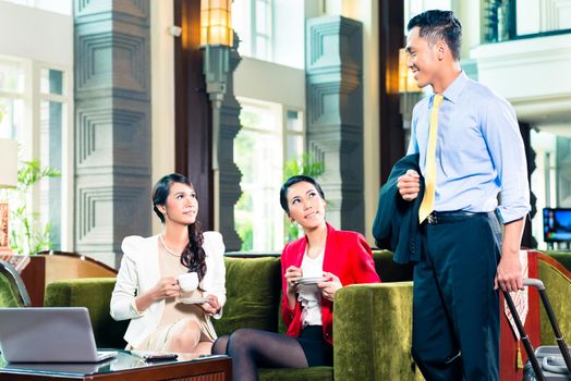 Asian Business people greeting each other in a hotel