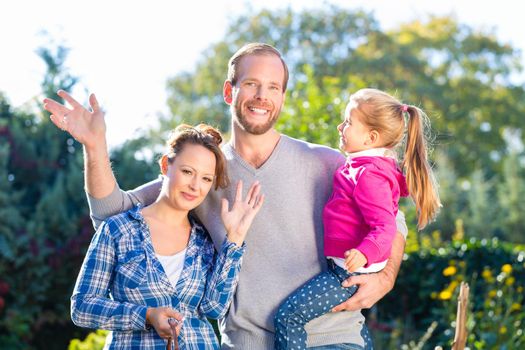 Mother, father and daughter in garden