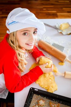 Mother and daughter baking Christmas cookies at home in domestic kitchen