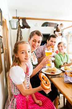 Bavarian family having traditional meal in German restaurant
