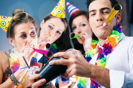 Party People in bar celebrating carnival, group having fun with drinks and a barkeeper