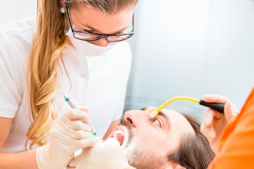 Patient having dental deep tooth cleaning at dentist