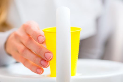 Patient rinse mouth with a cup of water at dentist