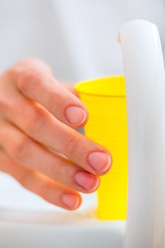 Patient rinse mouth with a cup of water at dentist