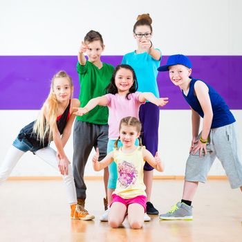 Children in zumba class dancing modern group choreography