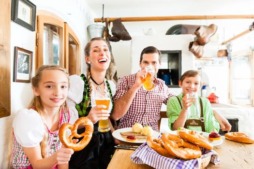 Bavarian family having traditional meal in German restaurant