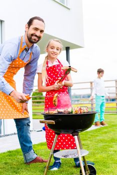 Family barbecue together in garden home