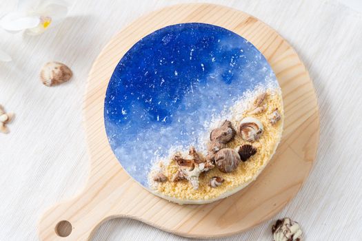 Summer theme no baked ocean blue cheese cake with chocolate seashells decoration