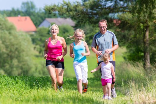 Parents with two children sport running outdoors