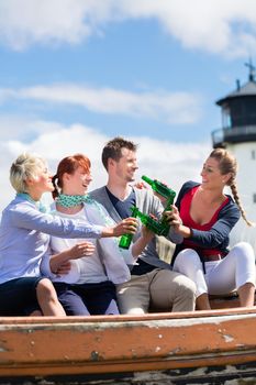 Friends drinking bottled beer enjoying vacation at German north sea beach