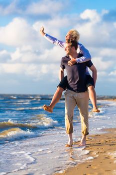 Couple enjoying romantic sunset at German north sea beach