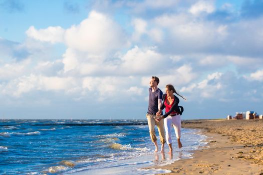 Couple enjoying romantic sunset at German north sea beach