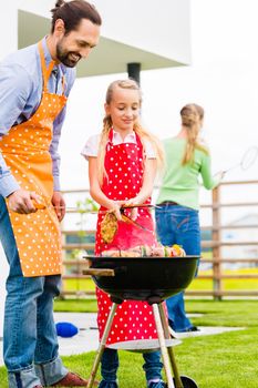 Family barbecue together in garden home