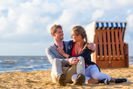 Couple enjoying romantic sunset at German north sea beach