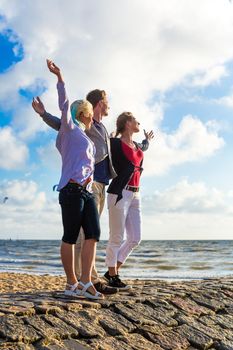 Friends enjoying sunset at German north sea beach