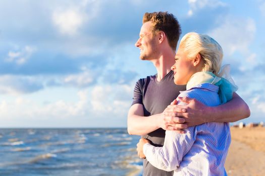 Couple enjoying romantic sunset at German north sea beach