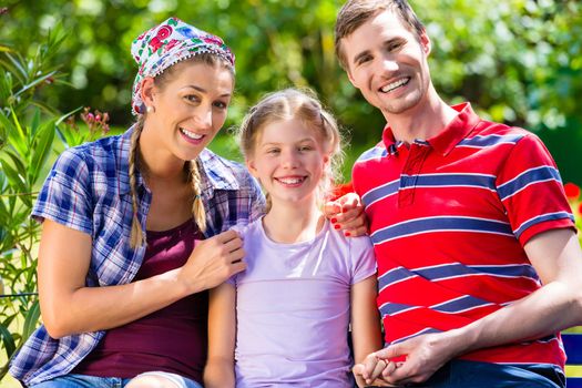 Family in garden sitting on bench