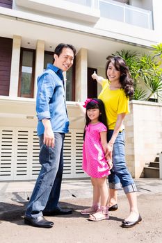 Chinese Family in front of house in residential area in Asia