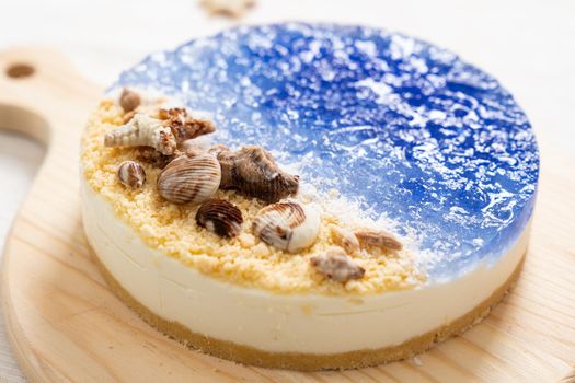 Summer theme no baked ocean blue cheese cake with chocolate seashells decoration