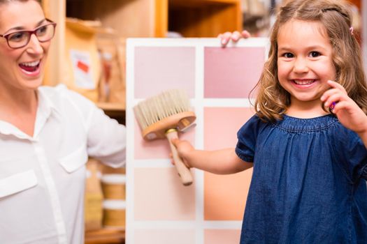 Family with paint sample card in store