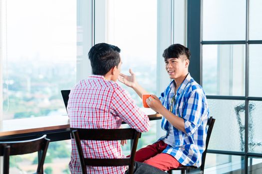 Asian casual business people discussing in office