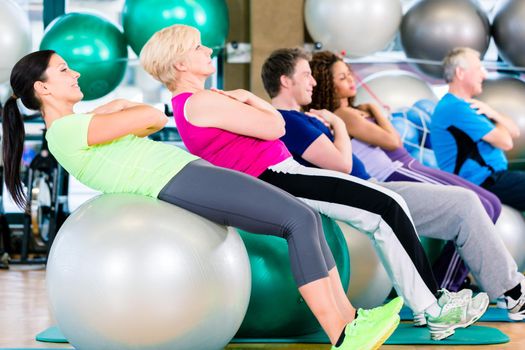 Group of young and senior people exercising in gym, diversity group of and white people