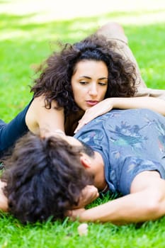Couple, Latin man and woman, girlfriend and boyfriend, on meadow sleeping in summer