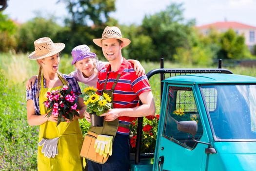 Family in garden with flowers