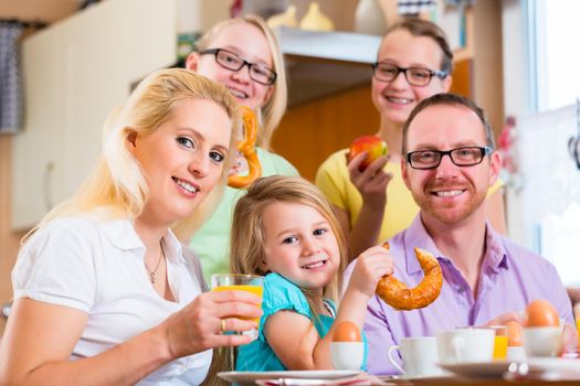 Family eating in kitchen having breakfast together