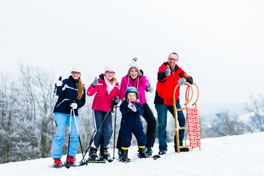 Family in winter vacation doing sport outdoors