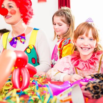 Clown at children birthday party entertaining the kids