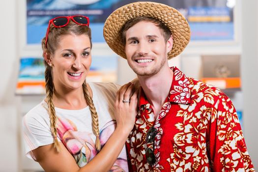 Tourist couple in travel agency