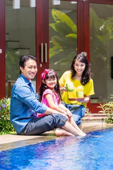 Chinese Family at pool in front of home or house drinking coffee