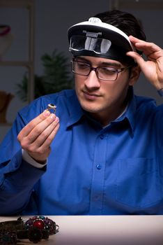 Jeweler working in his workshop late at night