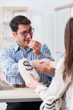 Woman visiting jeweler for jewelery evaluation