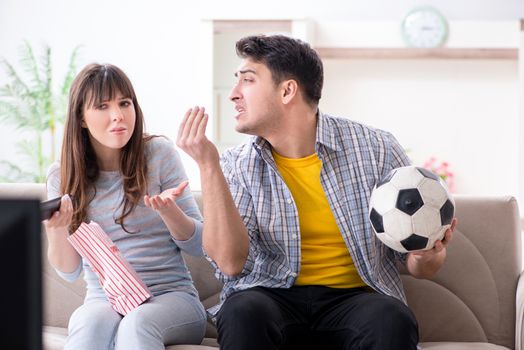 Family pair watching football at home