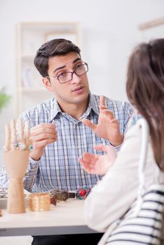 Woman visiting jeweler for jewelery evaluation