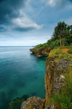 Blue beach with rocks and houses on the shore with copy space for text, Blue beach with copy space for tourism advertising