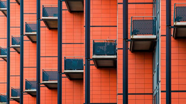 Building with many balconies, Pattern of the facade of a building, Balconies. Geometry minimalist art red