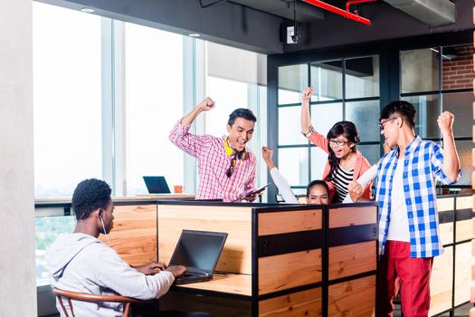 Start-up business people in cubicles working together having success