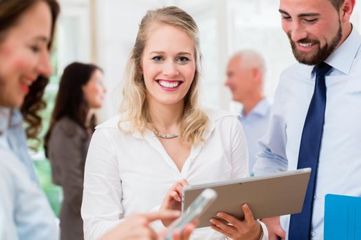 Business people in office having informal meeting and short presentation