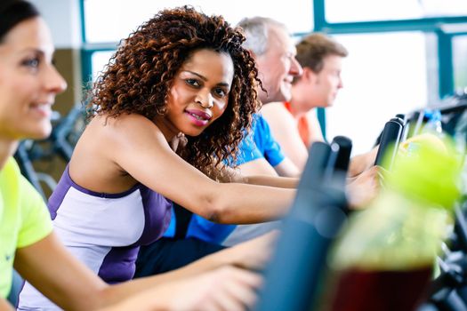 Diversity group of young and senior, Caucasian and black people on treadmill in gym