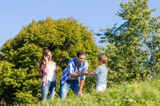 Family in grass on meadow