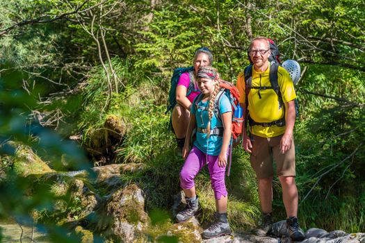 Family on a hike standing close to river