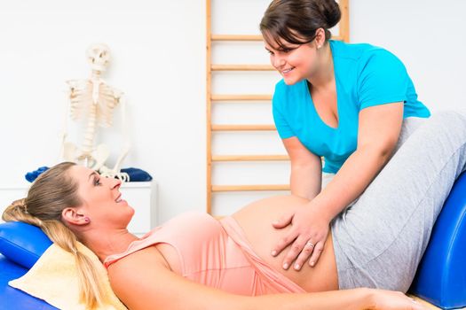 Pregnant woman at physical therapy on couch with terapist