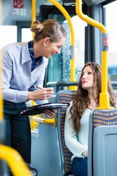 Woman in bus having no valid ticket at inspection