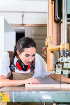 Carpenter woman cutting board with jig saw