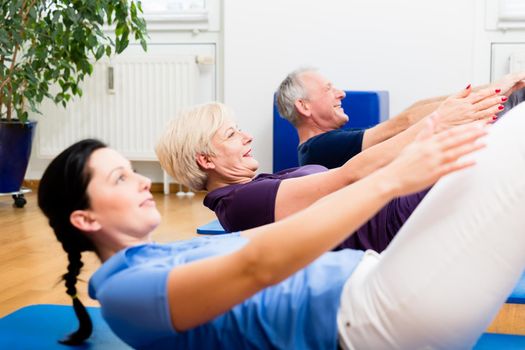 Physio giving gymnastic class for seniors