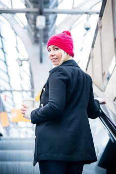 Woman walking on train platform looking around